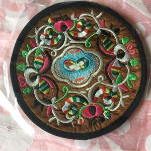 A pair of embroidered coasters